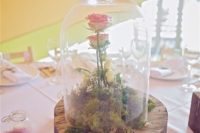 21 a moss and pink roses centerpiece on a large wooden slice