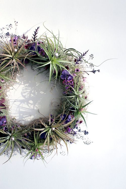 living air plants, Spanish moss, hand-dried seasonal purple flowers, and other subtle sparkling foliage details