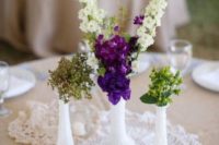 22 milk glass bud vases and doilies for a simple, delicate, and inexpensive centerpiece
