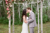 22 rustic wedding arch decorated with greenery and pink blooms