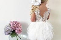 23 a knee dress with a feather-inspired skirt and a lace bodice with a V cut