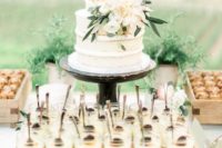 23 a naked wedding cake with neutral blooms