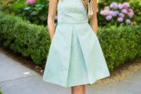 24 a mint knee dress without sleeves and yellow shoes and earrings