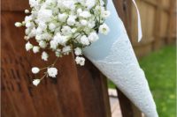 24 colored paper and a paper doily with baby’s breath for aisle chair decor