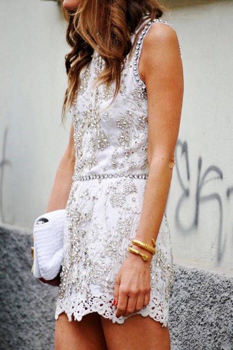 heavily jeweled white lace mini dress and a white clutch