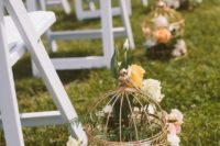 25 vintage birdcages line the aisle and were filled with flowers for a romantic look