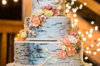 26 a multi-tiered birch cake topped with edible flowers
