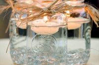 26 mason jars with twine and floating candles for decorating your rustic affair