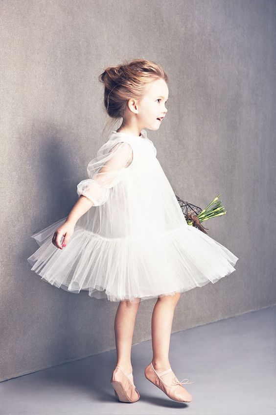 flowy white tulle dress with half sleeves and a ruffled skirt