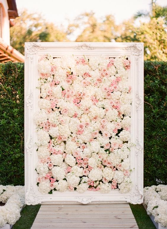 a blush and white floral framed backdrop
