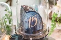 28 a giant agate slice with a table number in a cloche is a trendy idea