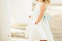 28 high low ivory dress with a mint sash and a large mint flower in the hair