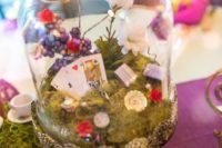 29 Alice in Wonderland inspired centerpiece with moss, flowers and cards