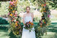 29 a bright floral wreath backdrop for summer wedding ceremony