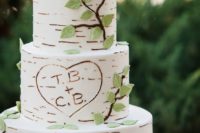 29 birch-inspired wedding cake with a bird topped and green leaves