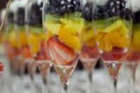29 glasses with fruits and berries and whipped cream on top