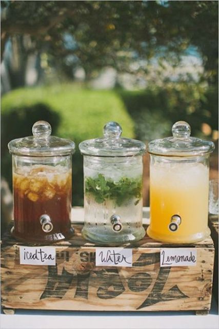 wooden crate and glass tanks with various drinks are a must for an outdoor wedding
