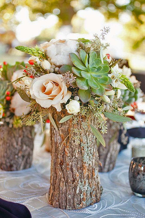 a wood log as a vase for fresh flowers, succulents and cotton