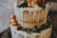 31 semi naked wedding cake with dripping, donuts and fresh greenery