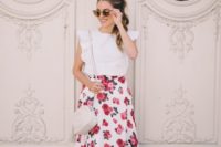 32 a pink floral printed skirt, a white ruffled top and nude heels