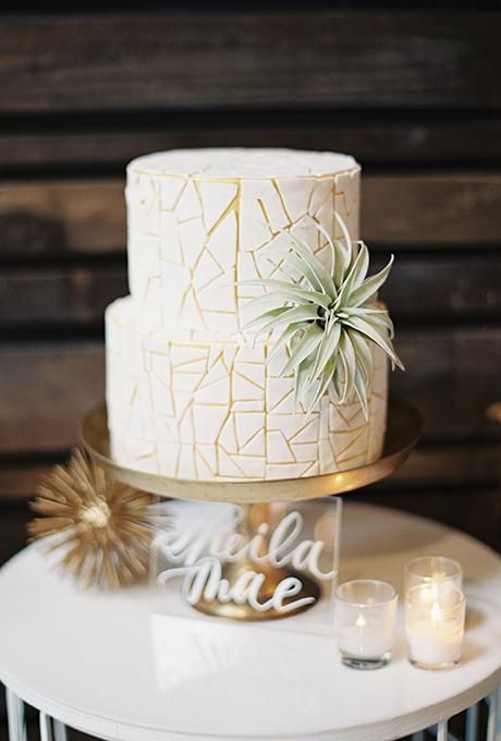 geometric wedding cake with an eye-catchy pattern and an air plant