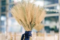a simple wheat wedding centerpiece