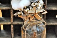 a rustic wedding centerpiece of berries, allium, cotton and dried touches is a lovely and very beautiful decor idea for any wedding