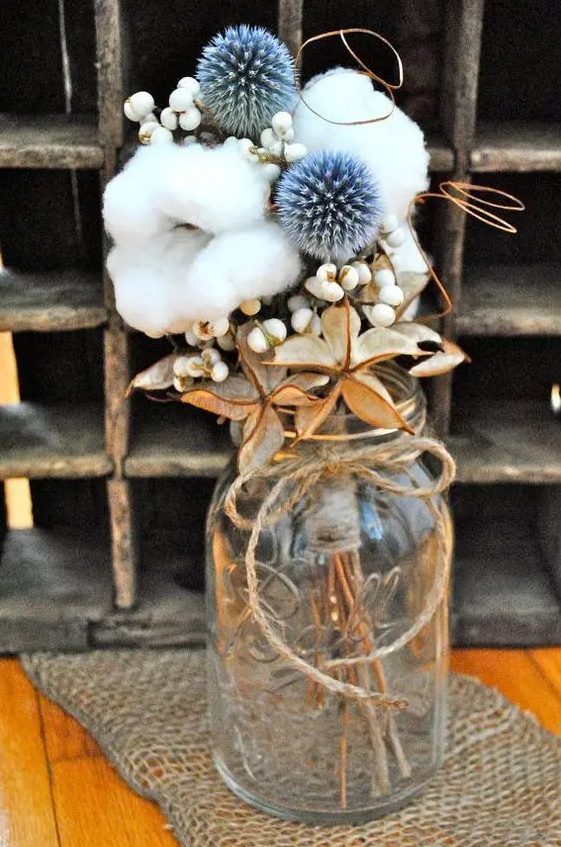 a rustic wedding centerpiece of berries, allium, cotton and dried touches is a lovely and very beautiful decor idea for any wedding