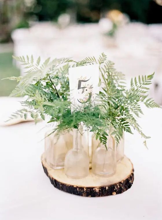 Flower and Table Number on Wood Slab  Wood slab centerpiece wedding, Wood  slice centerpiece wedding, Wedding centerpieces diy