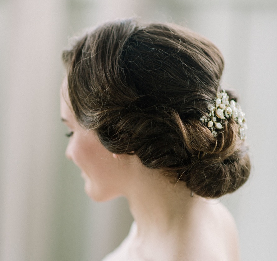 A simple and elegant bridal twisted updo with a bead and pearl headpiece