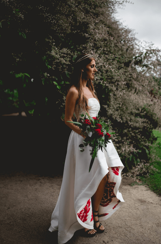 The wedding dress was designed especially for the bride, it was a strapless high low one with a bold sash and printed red lining