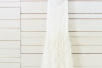 02 Unique wedding dress with an illusion neckline topped with pearls and a feather skirt