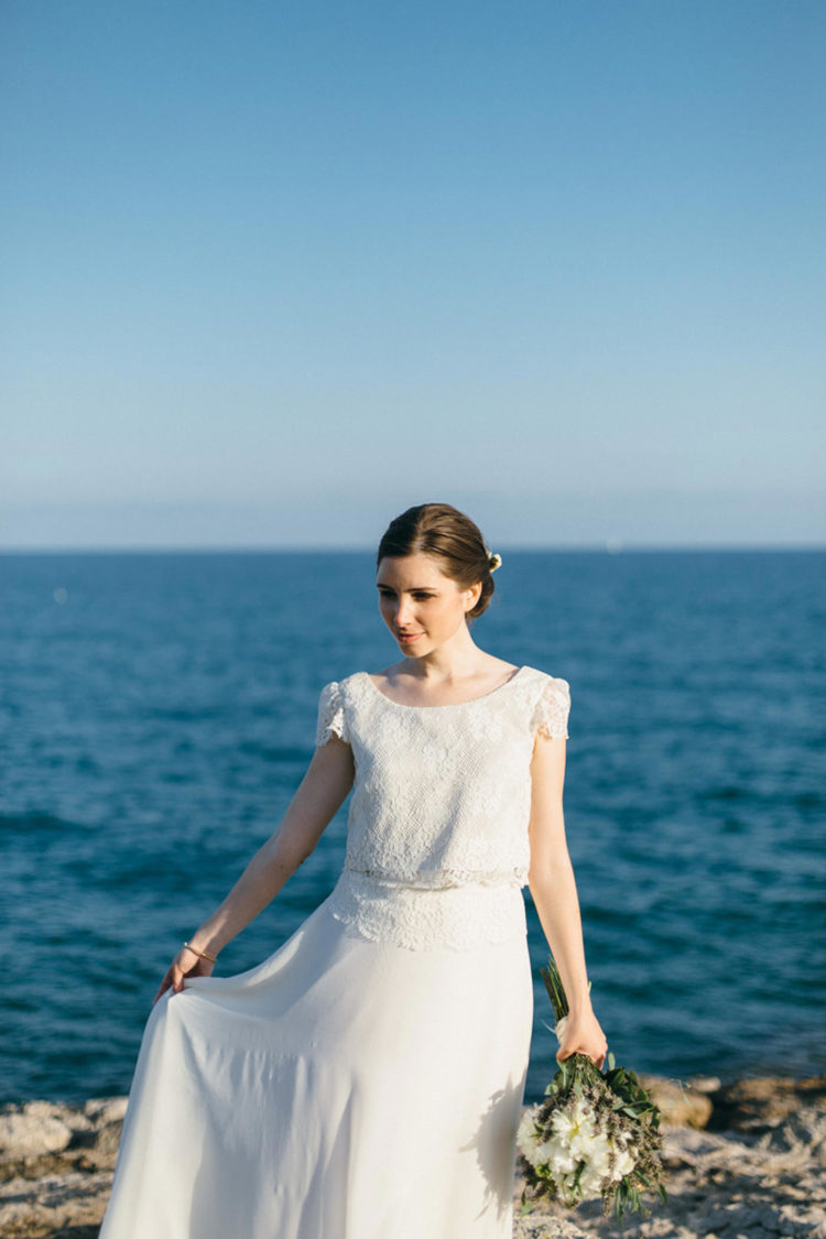 The bride was wearing a chic separate with a lace bodice with cap sleeves and a plain skirt topped with lace