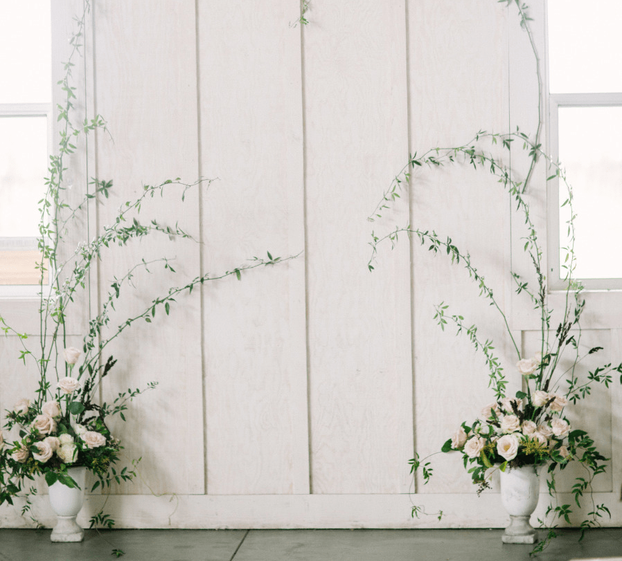 The ceremony space was defined by two vases with blush roses and greenery