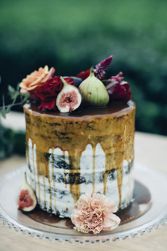 semi naked wedding cake with caramel drip, fresh blooms and figs