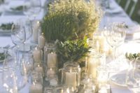 simple potted plants and greenery with lots of candles can comprise great centerpieces