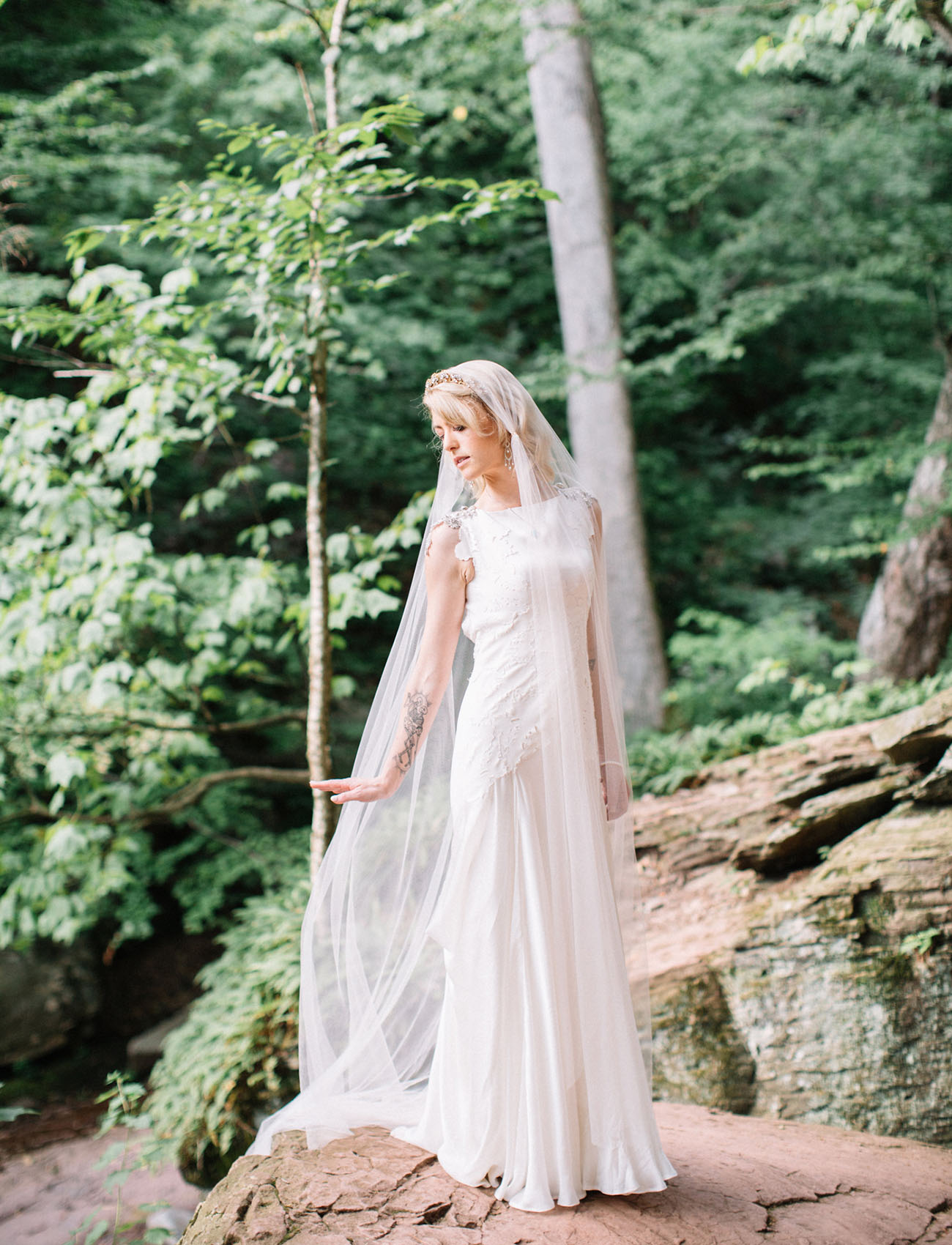 The bride was wearing a Carol Hannah gown with lace appliques and jeweled cap sleeves, a long veil