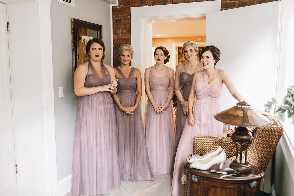 The bridesmaids were wearing mismatching lavender dresses