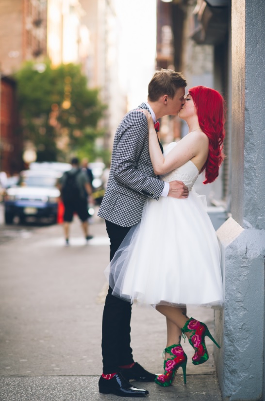 The groom was wearing black pants, a gingham jacket and bold socks and a bow tie