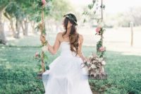 04 a cool swing decorated with leaves and pink blooms for bridal pics