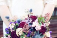 04 a wedding bouquet with purple and burgundy blooms and thistle