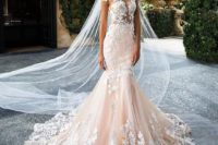 04 blush mermaid dress with an illusion bodice and white floral appliques over the whole gown