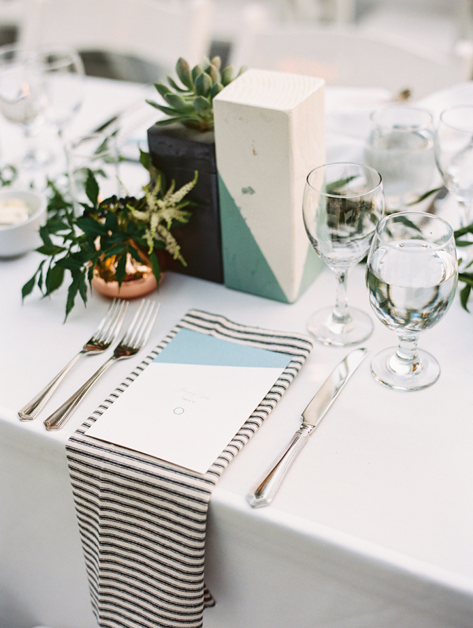Modern tablescape with color block geometric decorations, planters and candle holders