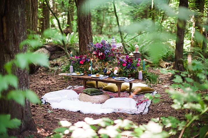 There was a low table laid right in the woods, with blankets and pillows around for a boho picnic