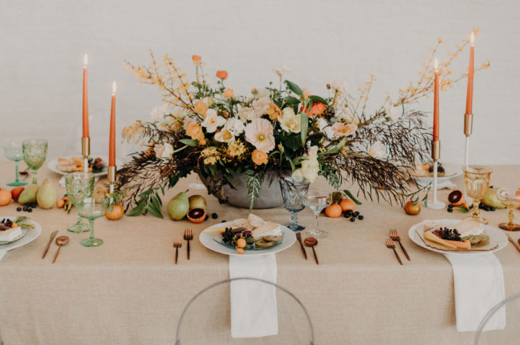 The tablescape was moody yet rather colorful, with lots of orange and fruits