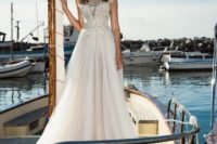 06 illusion neckline wedding dress with a lace applique bodice and a flowy skirt