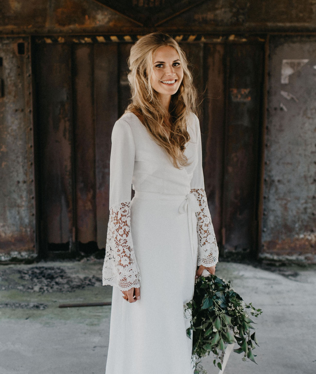 The bride designed her own boho inspired dress with a V neck and crocheted bell sleeves