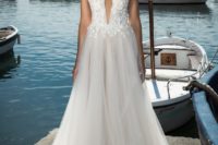 07 a white plunging neckline gown with lace appliques and a flowy skirt