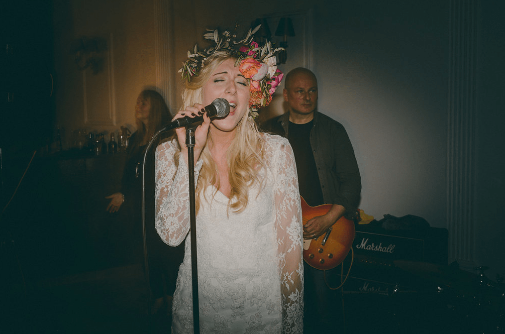 The bride was singing herself with the band