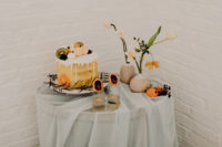 08 The dessert table with ethereal fabric and orange flowers